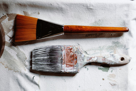 Two paint brushes, one old, one new